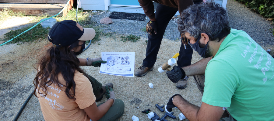 Two people looking at a graywater plan