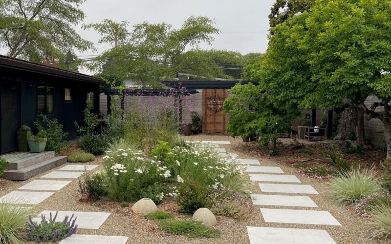 Pavers surround a wildflower centerpiece in the backyard