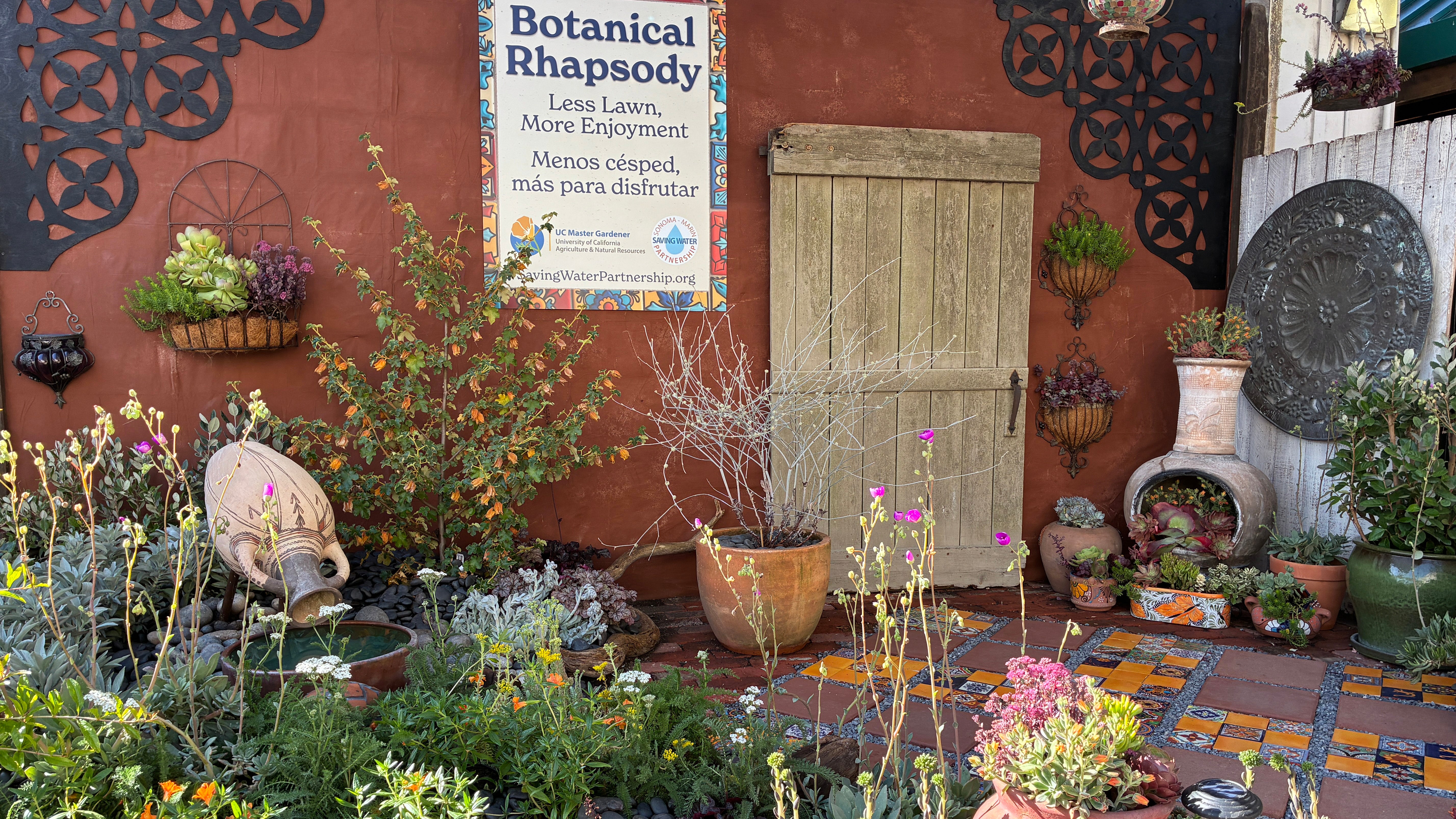Photo of the 2026 Sonoma County fair display titled Botanical Rhapsody featuring a Spanish themed tiled patio surrounded with low-water use plants.
